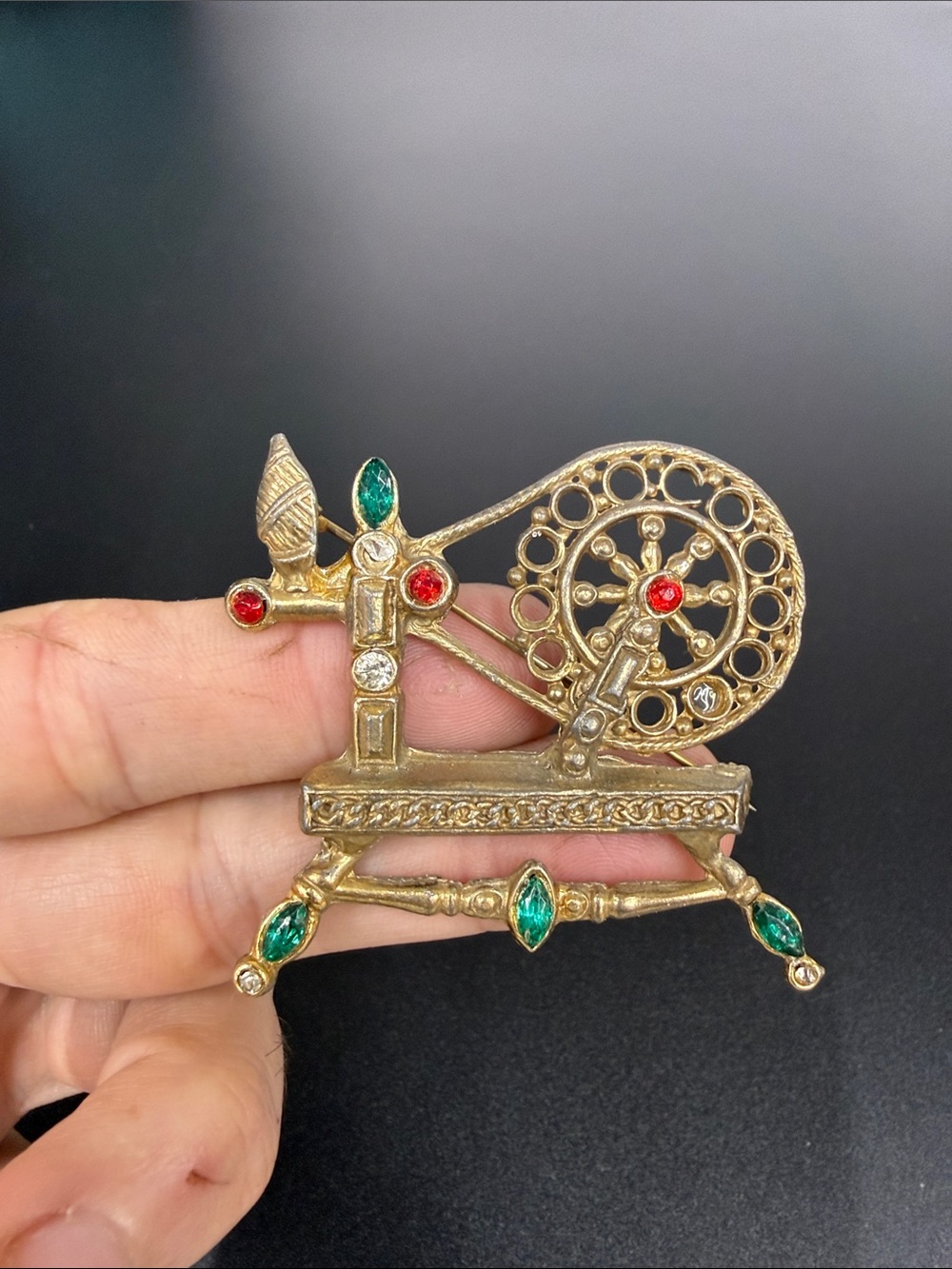 Gold-Tone Spinning Wheel Brooch with Red and Emerald Accents